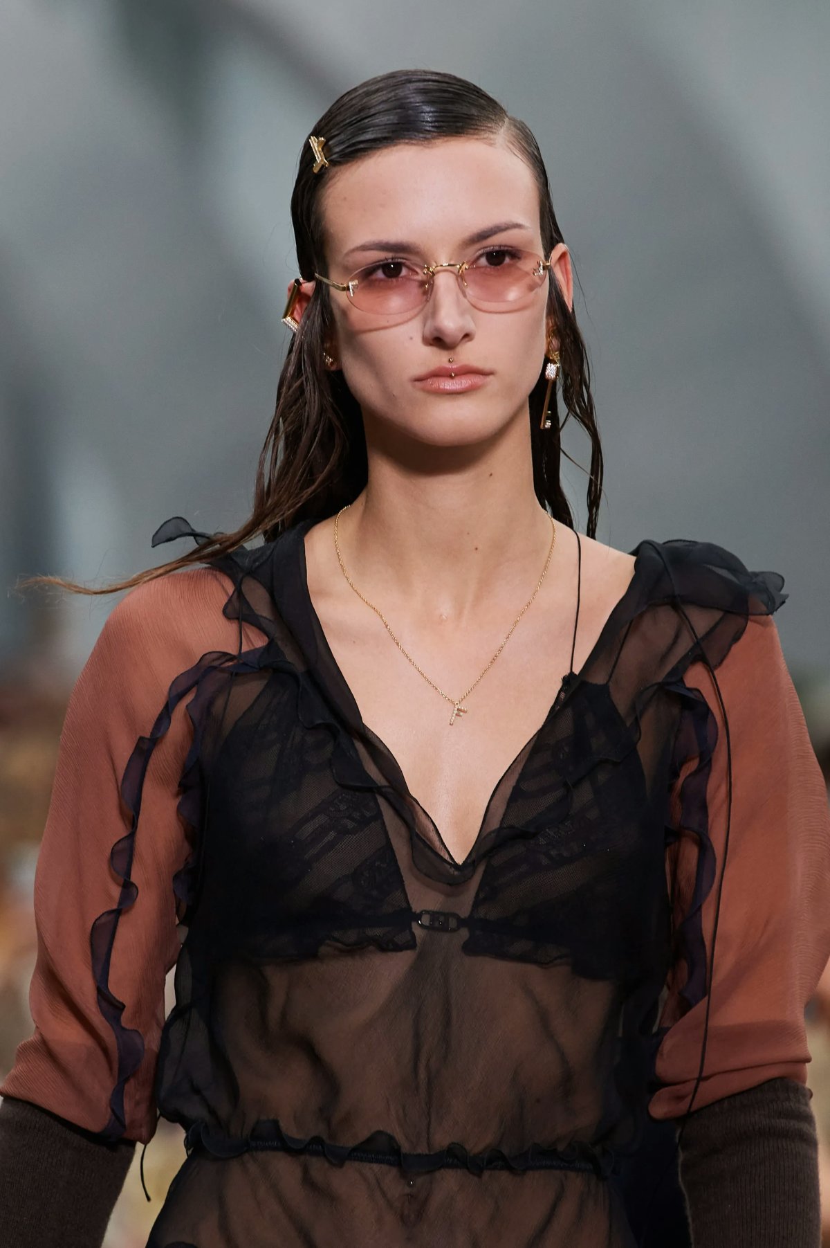 A model photographed wearing an oval-shaped sunglasses during Fendi Fall/Winter 2022 show