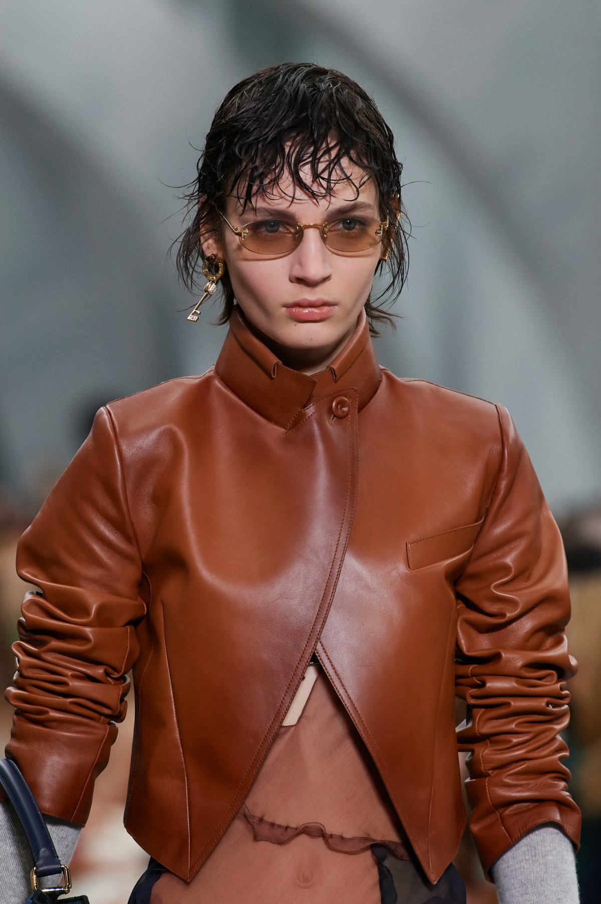 A model photographed wearing an oval-shaped sunglasses during Fendi Fall/Winter 2022 show