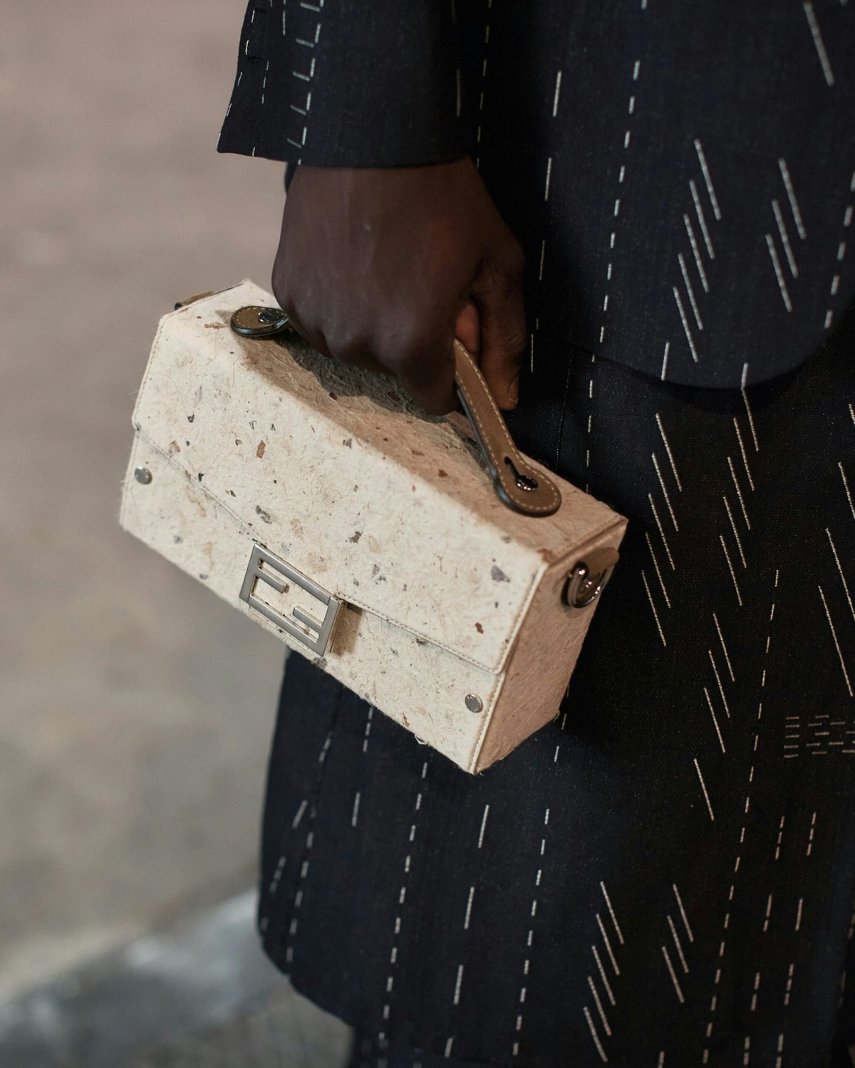 A white Fendi toolbox inspired mini bag.