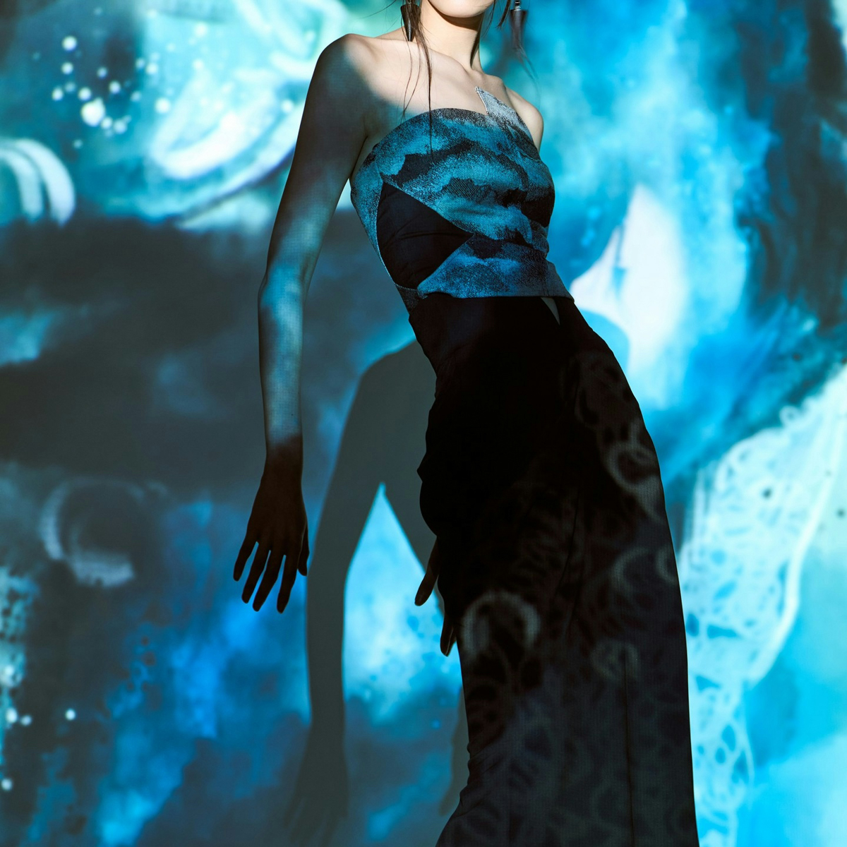 Model in front of blue underwater-looking background. Photo via Instagram/ @shanghai_fashionweek