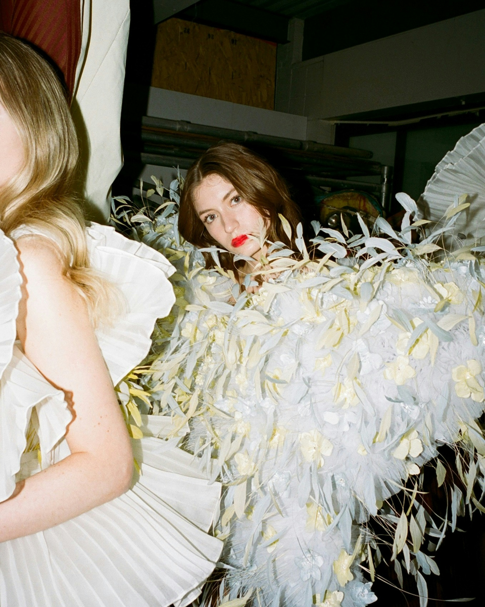 Two models in leaf covered outfit. Photo via Instagram/ @vanfashionweek