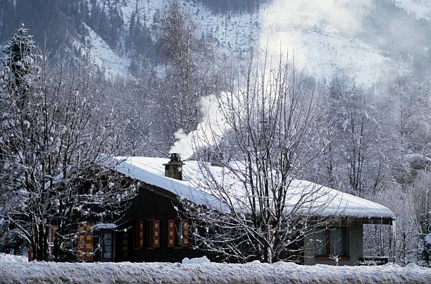 cabin at bottom of mountain in winter