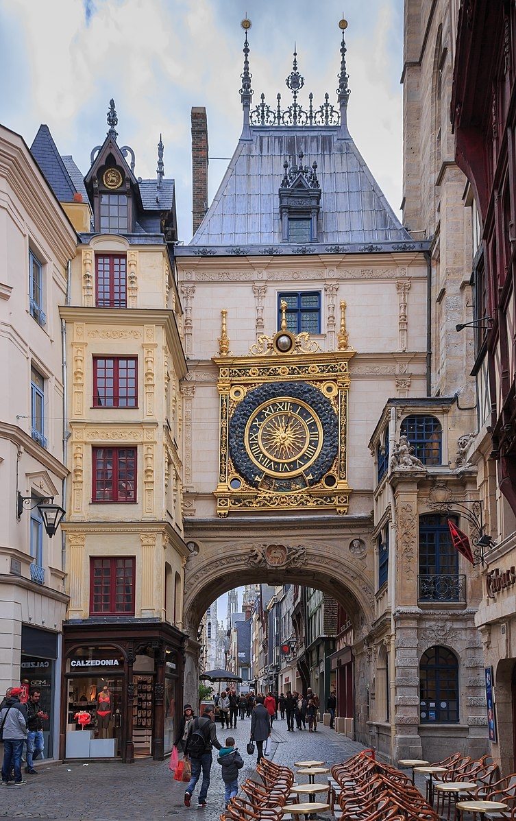 city street with large golden clock on tower