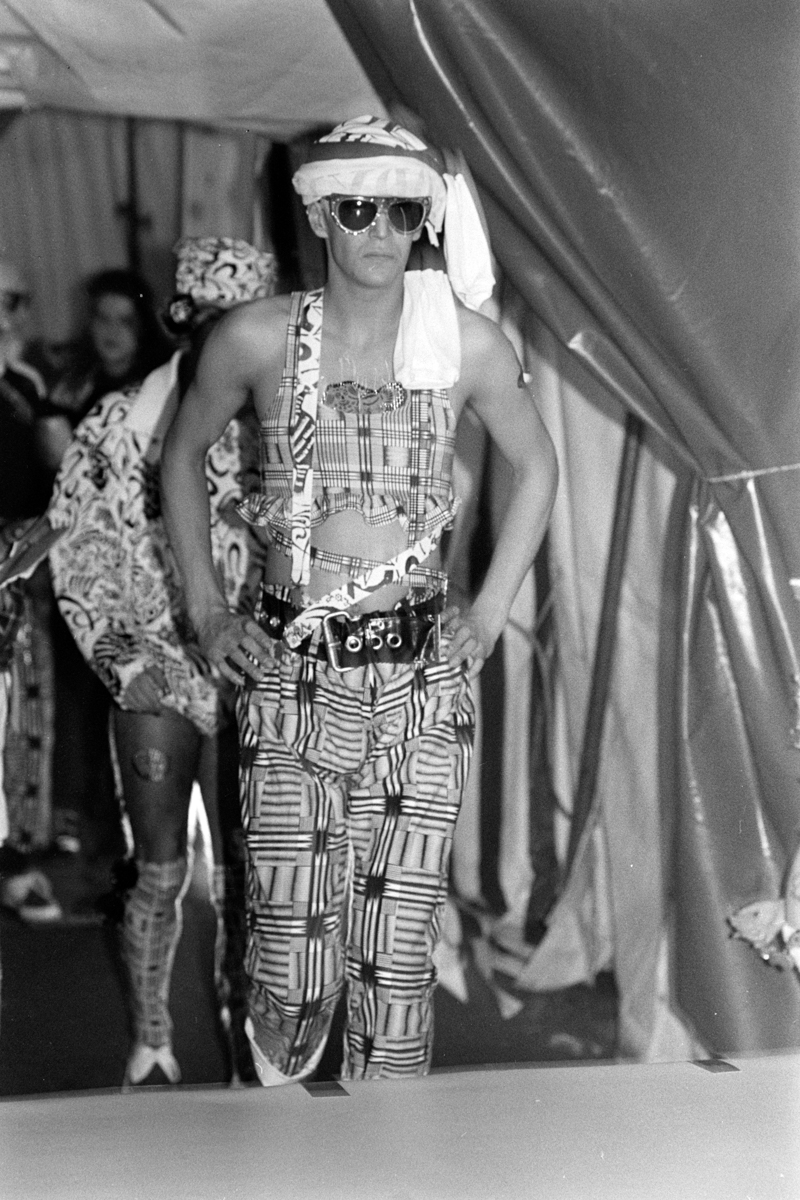 model on runway wearing tank top and patterned pants