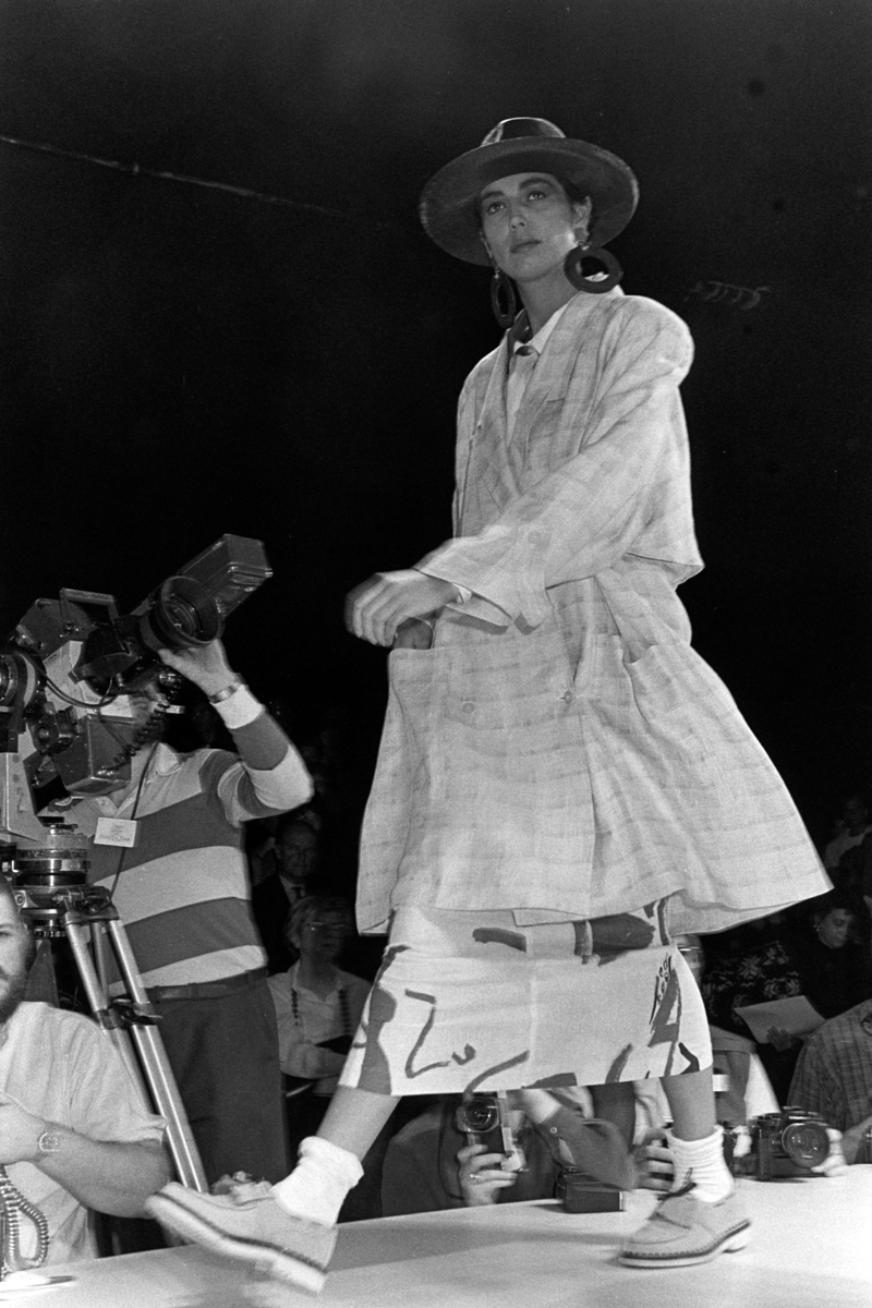 model on runway wearing plaid overcoat and loafers