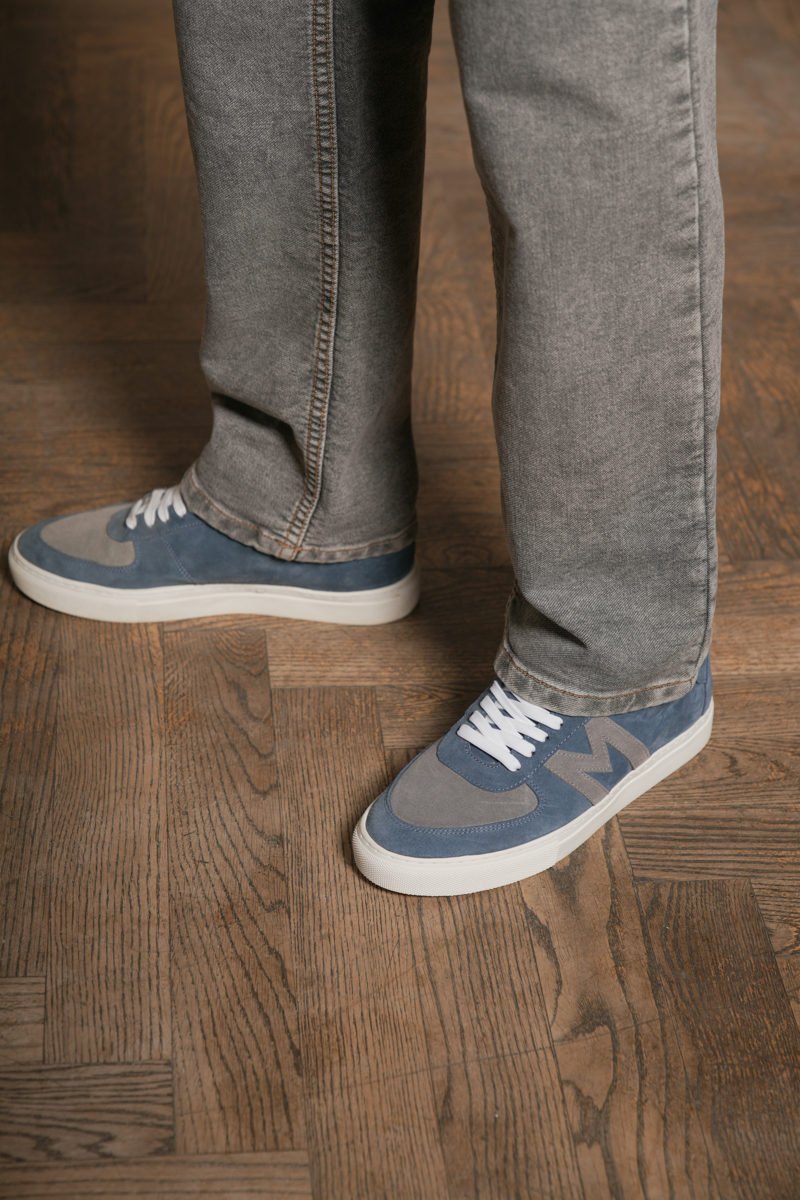 shoe sneaker floor flooring hardwood wood interior design pants jeans person
