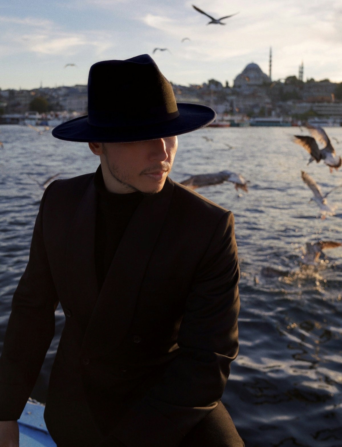 clothing hat sun hat adult male man person animal bird coat