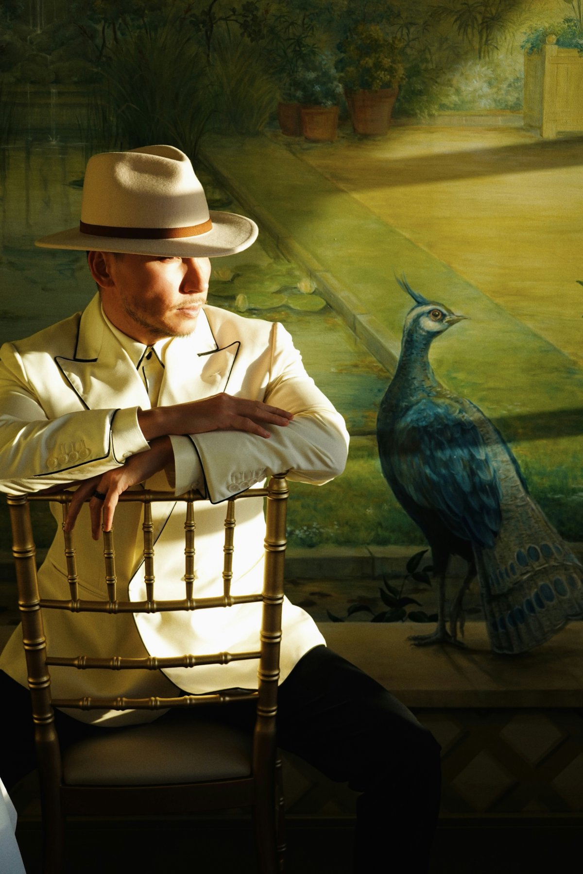 hat sun hat adult male man person bird plant chair portrait