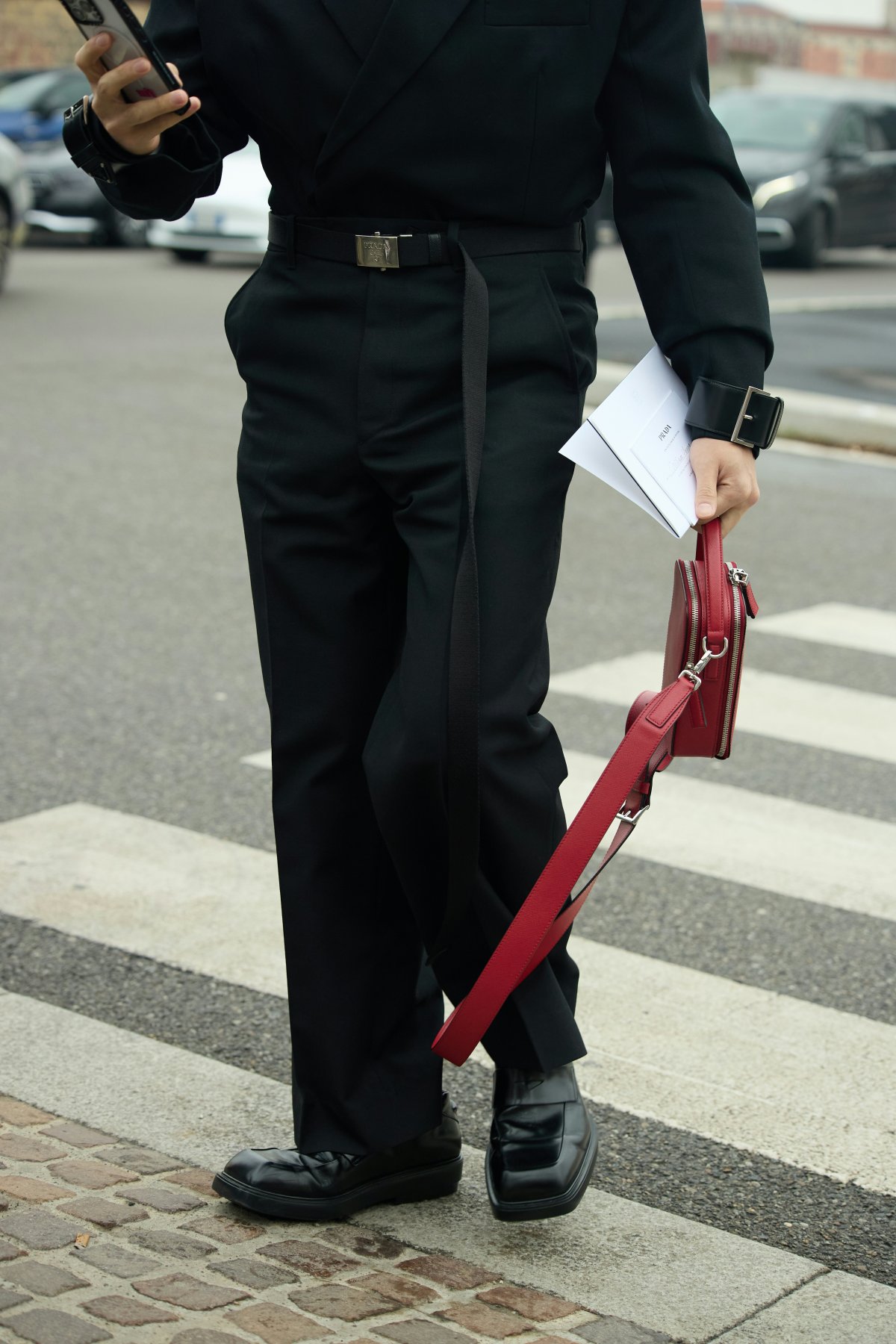 shoe handbag adult male man person road tarmac mobile phone walking