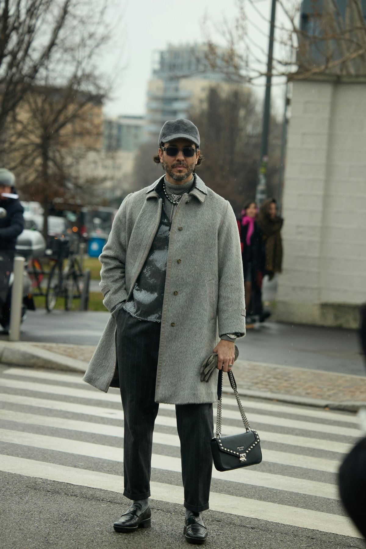 coat accessories bag handbag road tarmac overcoat purse person wheel