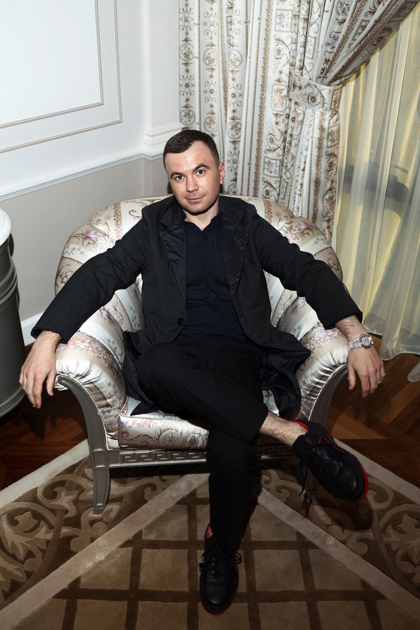 person sitting adult male man furniture footwear shoe face chair