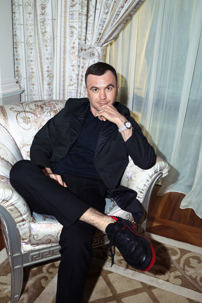 shoe person sitting couch adult male man sneaker face coat