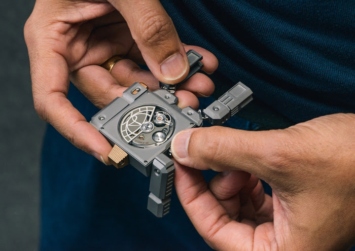 body part finger hand person wristwatch arm gun weapon jewelry ring