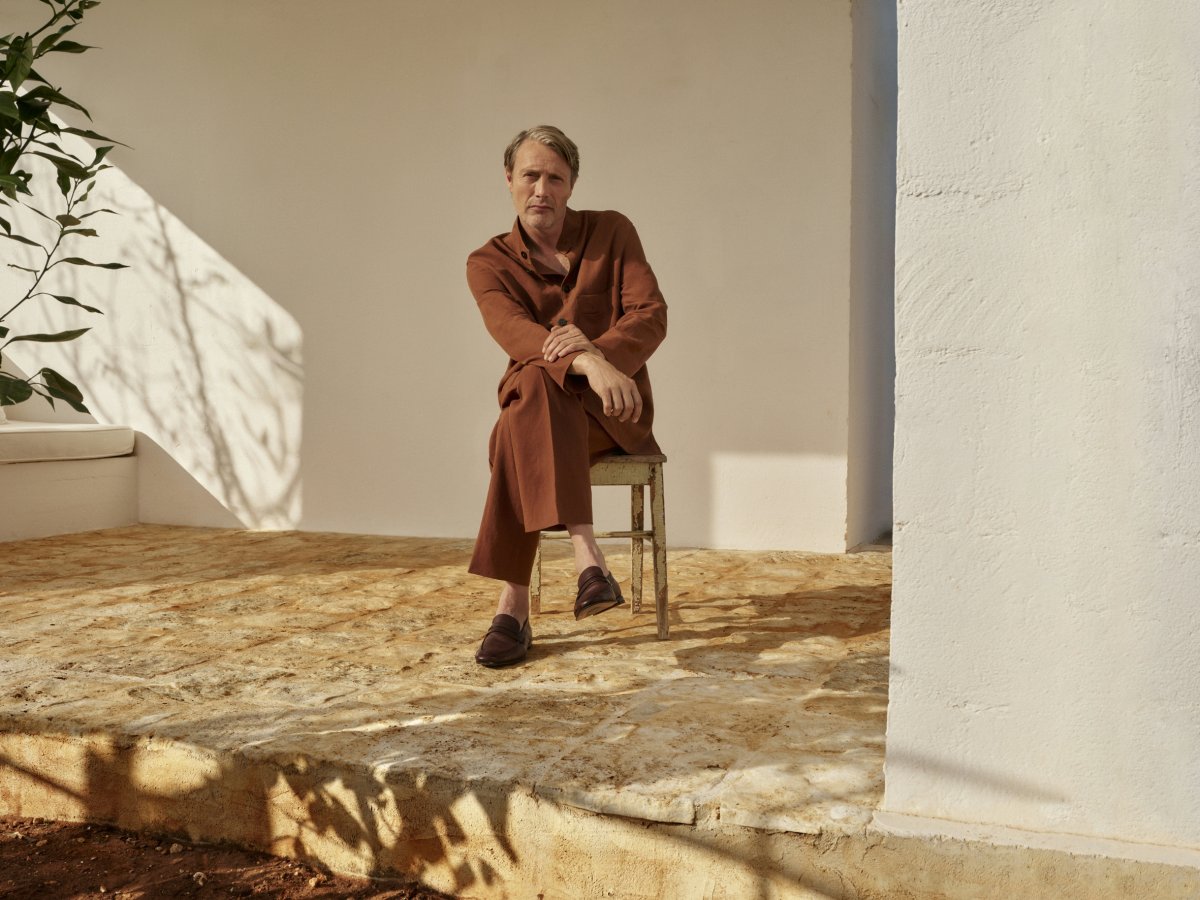 person sitting adult male man footwear shoe floor walkway chair